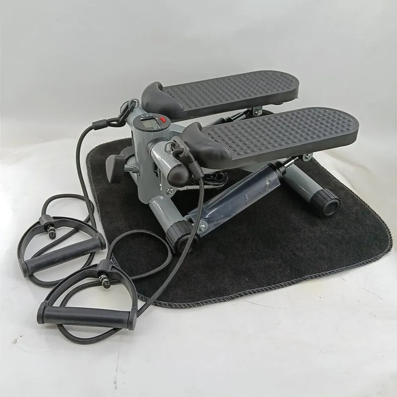 Silver grey mini treadmill waist slimming machine with hydraulic resistance and pedals.