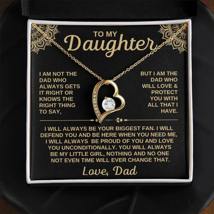 A hollow heart-shaped pendant necklace on a chain, presented in a gift box with a card.