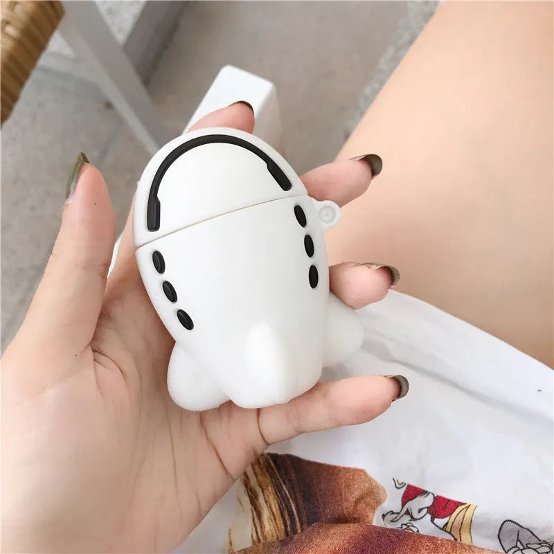 Silicone protective case for Apple AirPods with flip-top cover, cartoon aeroplane headset design, and detachable hook.