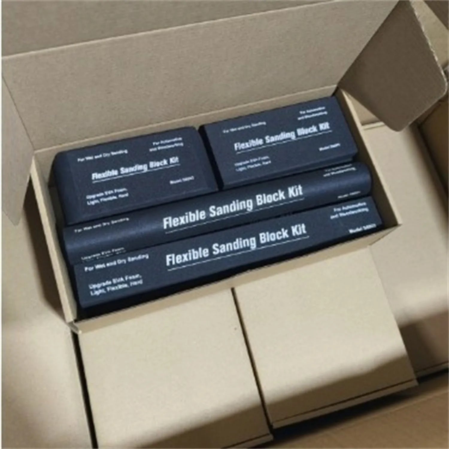 Seven black EVA frosted metal building blocks arranged together