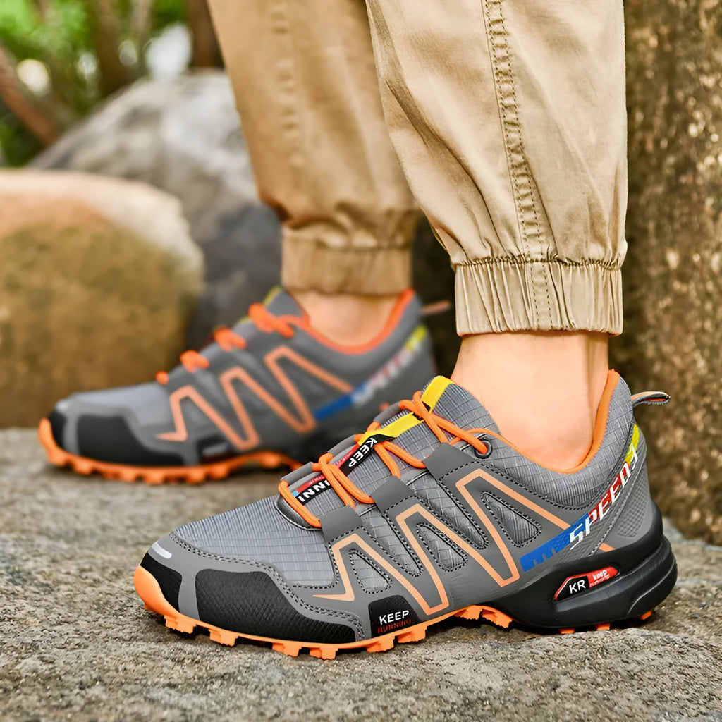 Men's grey and orange casual shoe with synthetic leather upper and non-slip rubber sole.