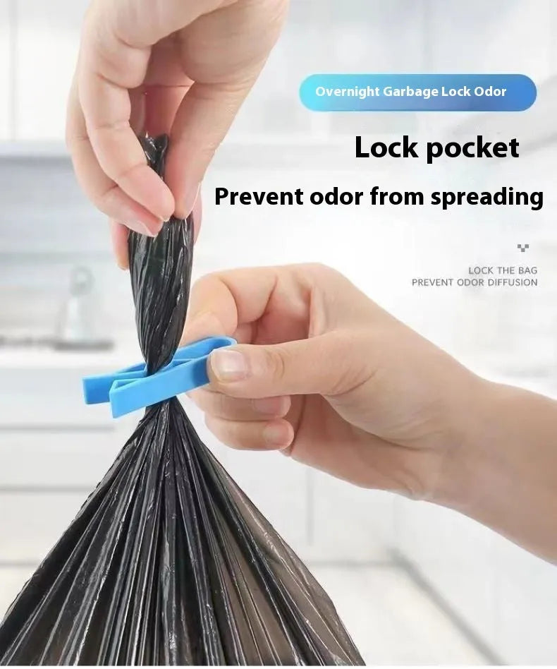 White PP plastic garbage bag fixing clip attached to the rim of a black indoor bin.
