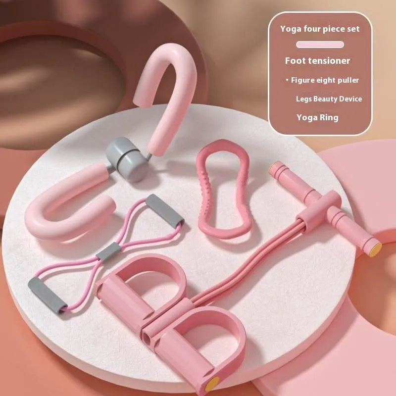 Yoga four-piece fitness set showing leg stretcher, ring, pedal device, and tension rope on a floor.