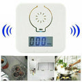 White wireless carbon monoxide alarm mounted on a wall for detecting coal stove gas.