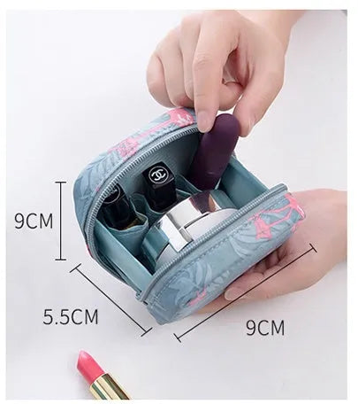 Blue cloth cube makeup storage bag with zip on a bathroom countertop.
