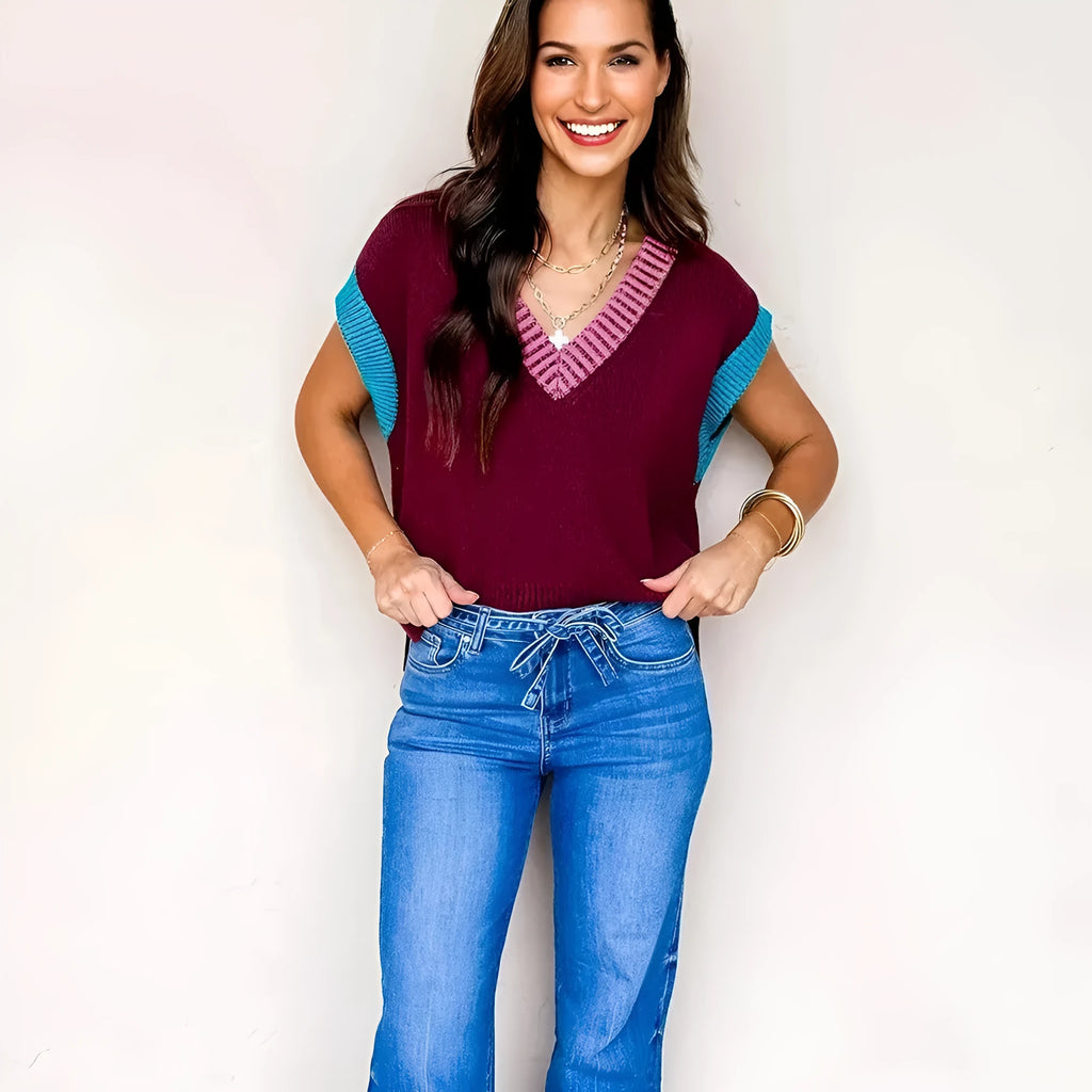 Burgundy women's V-neck sweater with contrast trim and cuffed short sleeves on hanger