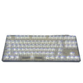 132 transparent plastic key caps arranged for a full-size keyboard layout