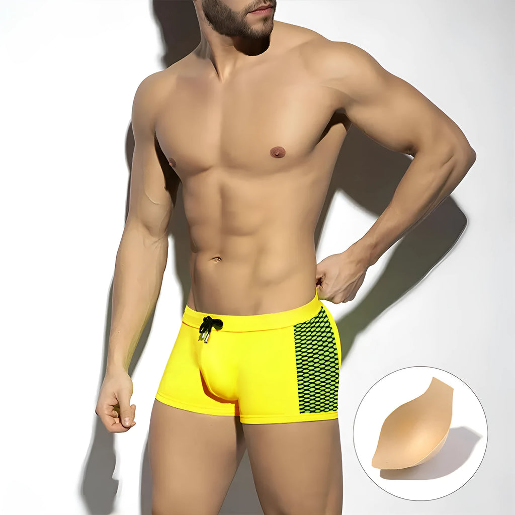 Men's black polka dot quick-dry swimming boxers briefs on a white background.