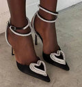 Women's pink satin sandals with a heart-shaped rhinestone and adjustable ankle straps.