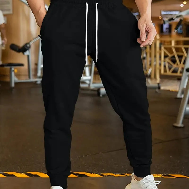 Men's loose-fit linen-look leisure trousers with a drawstring elastic waist in a light colour.