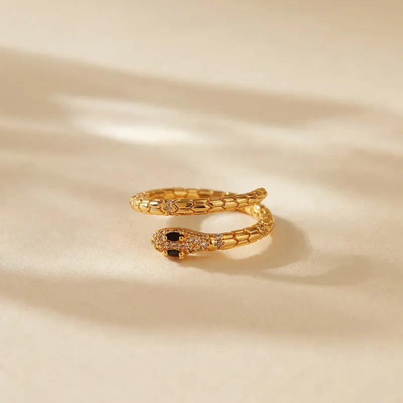 Snake-shaped adjustable copper ring with gold colour plating and diamond treatment