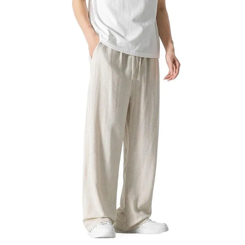 Men's beige bamboo fibre straight-leg cropped trousers with a drawstring waist on a neutral background.