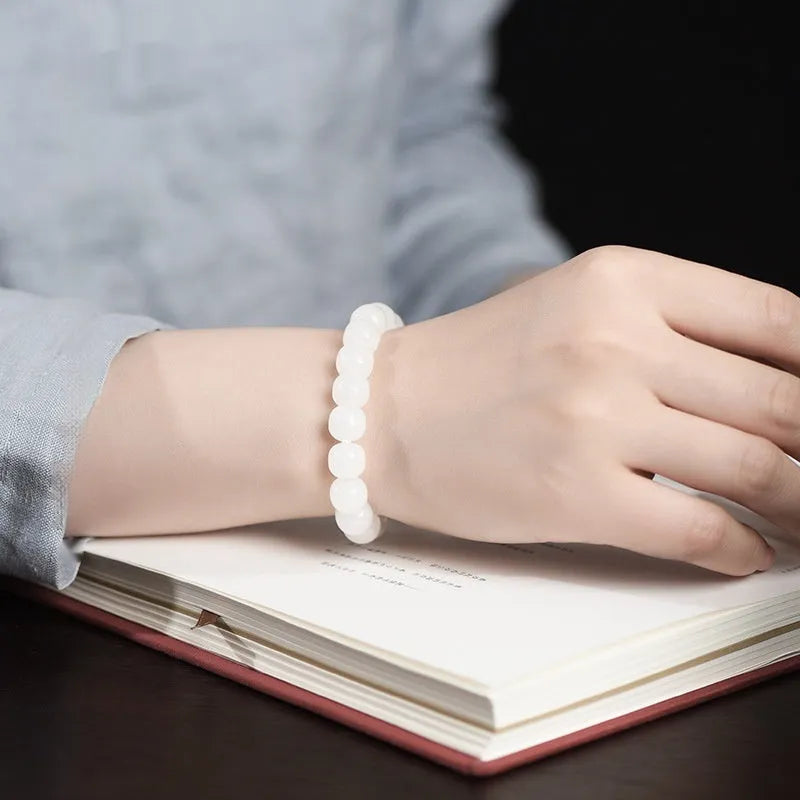 White Hetian jade barrel bead bracelet showing three bead size options on wrist