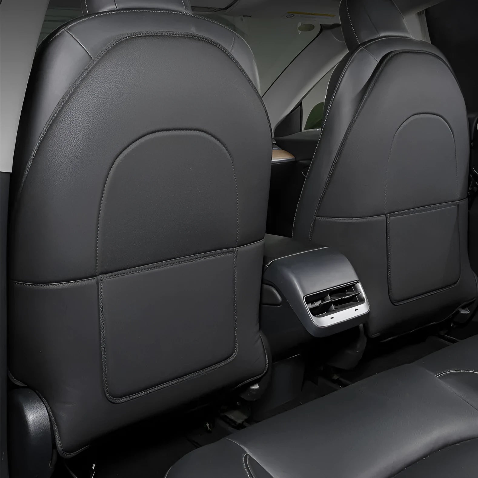 Black leather anti-kick pad for car rear seat protection, showing single pocket.