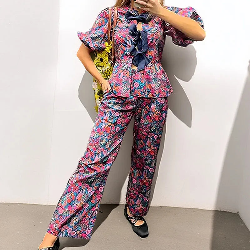 Floral printed tie-neck blouse and trousers suit set with puff sleeves.