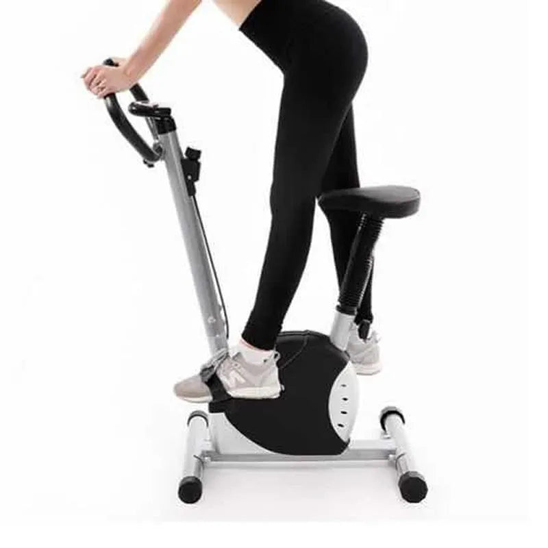 Grey spinning fitness bicycle with steel frame and foam handlebars for home office cardio training