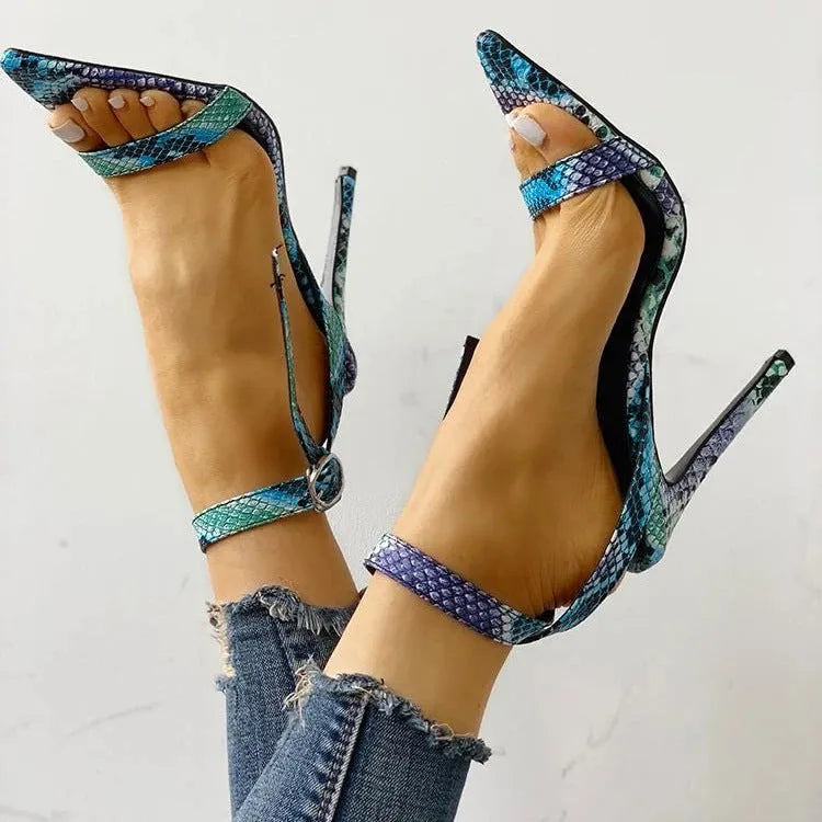 Blue serpentine-style women's high heels with buckle fastening and hollow-out details, shown from the side.