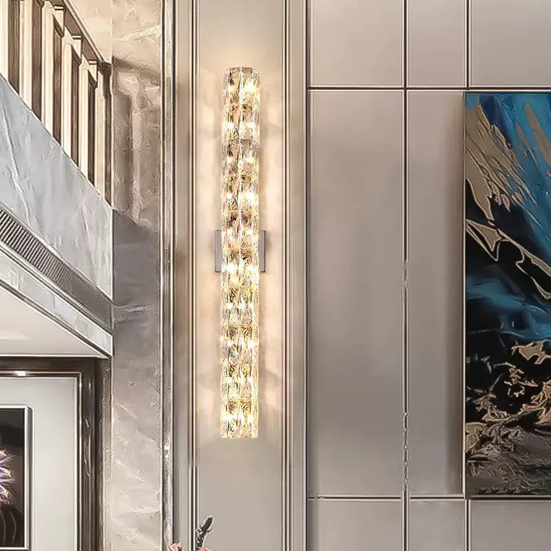 Crystal shade stainless steel wall lamp in chrome finish mounted on a wall.