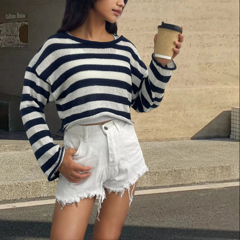 Woman wearing a striped cropped long-sleeved sweater in coloured cotton, showcasing the front and back wearable design.