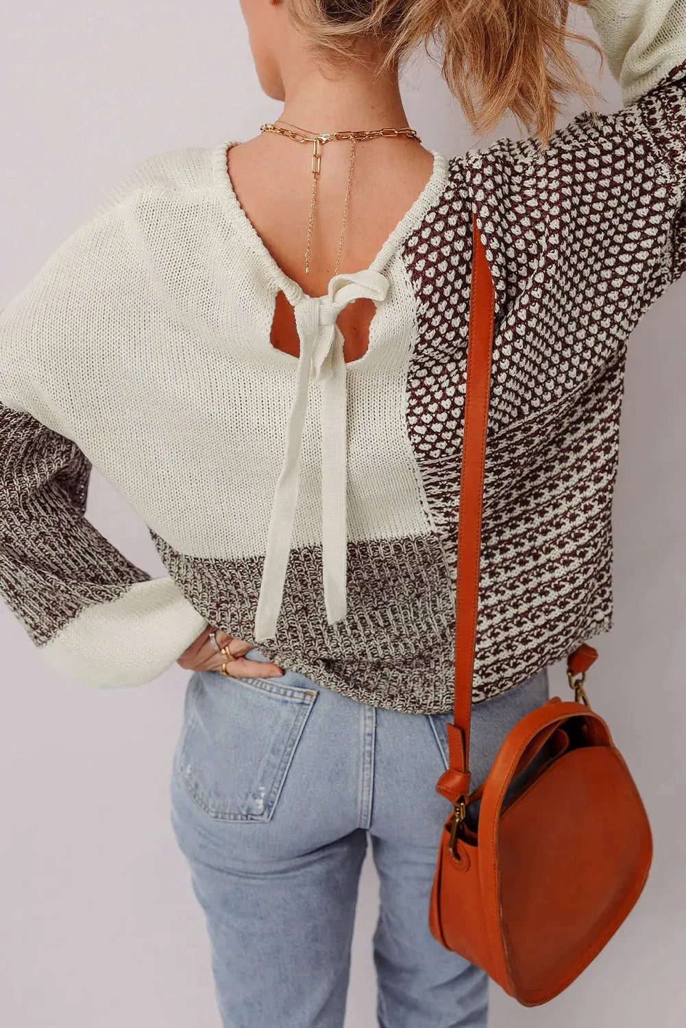 Dark khaki loose knit sweater with drop shoulders and a back tie detail.