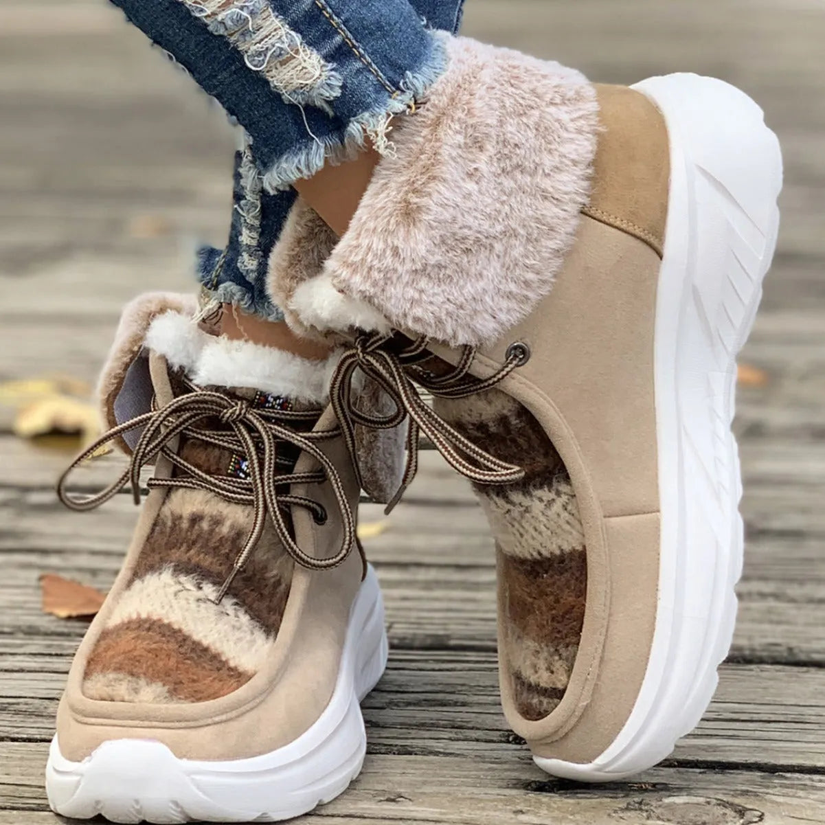 Beige women's lace-up mid-top snow boots with fuzzy lining and a thick rubber sole.