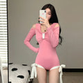 Women's long-sleeve one-piece swimsuit in black or pink colour with polyester construction