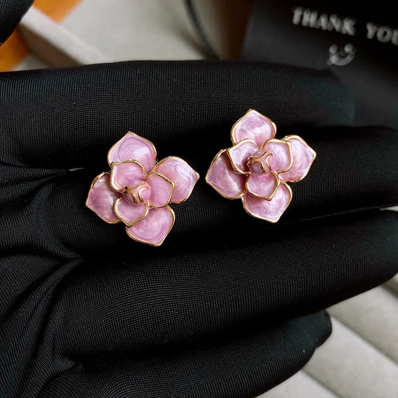 Gold plated purple oil-spot glaze flower stud earrings with copper construction and fresh floral design