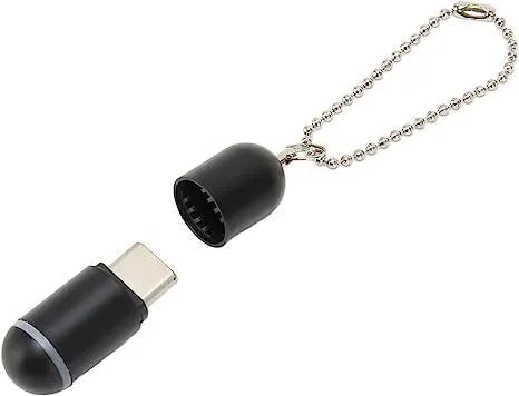 Small black capsule infrared remote control adapter for smartphone.