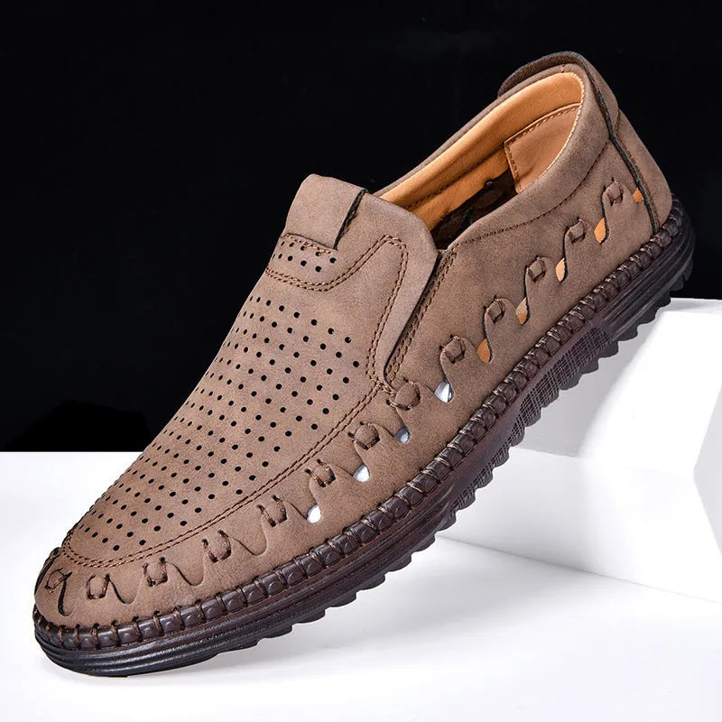 Men's brown slip-on casual leather shoes with round toe and flat PVC sole on a white background.