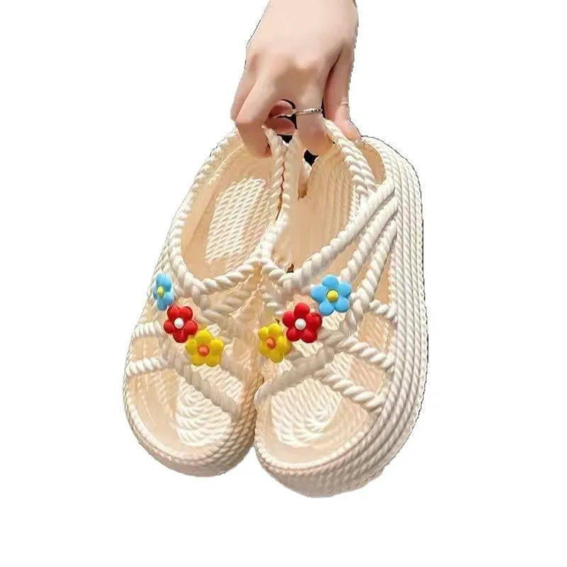 Beige PVC sandals with a round toe, sunflower design, and non-slip sole.