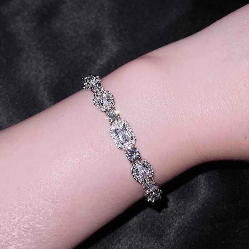 Women's sterling silver-plated bracelet with zircon stones on a geometry-patterned chain.