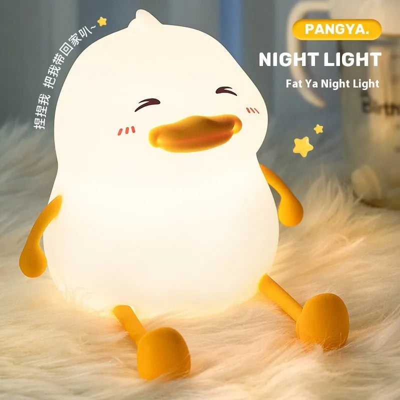 Chubby silicone night light with phone holder slot, showing touch controls and soft LED glow