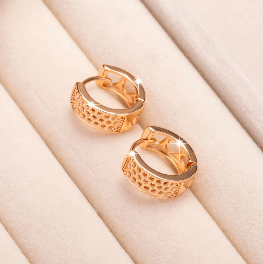 Rose gold electroplated women's earrings with three hollowed heart shapes in circular arrangement