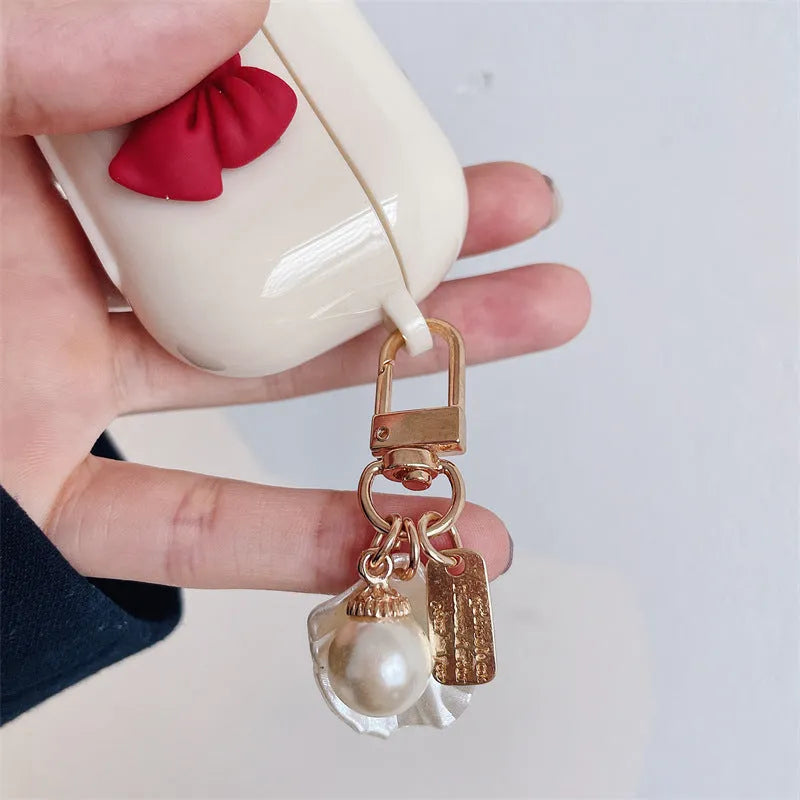 Beige red bow shell clamshell TPU protective cover for AirPods Pro wireless earphone case.