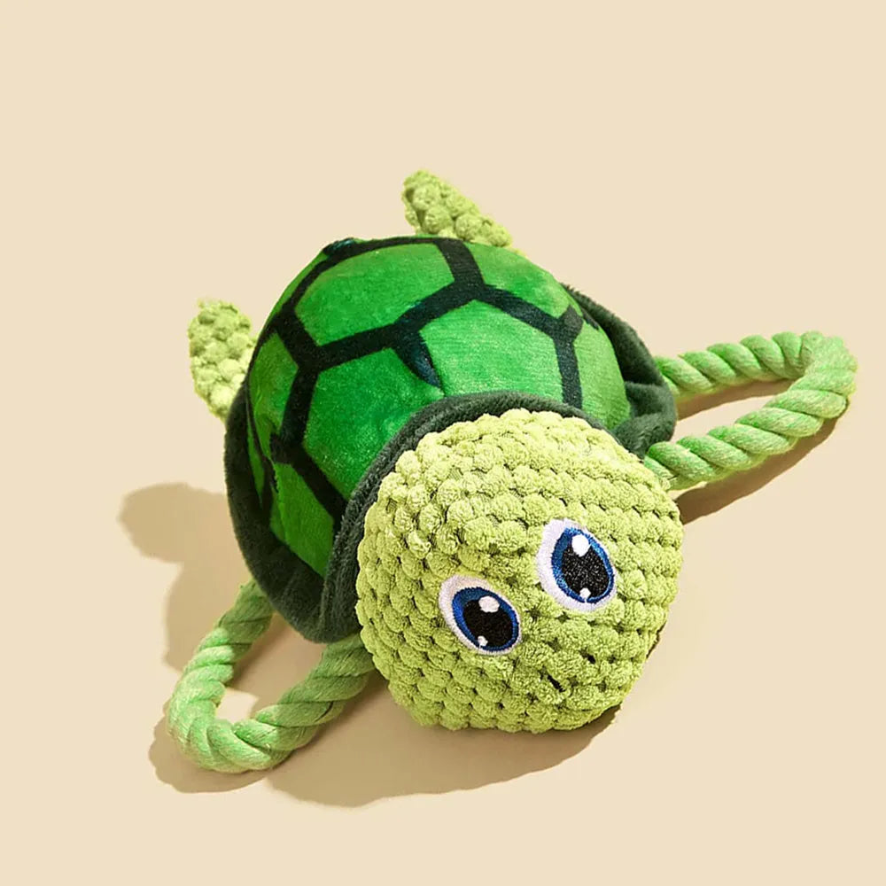 Grey, green, and orange turtle-shaped plush dog toy with a knotted rope chewing core