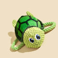 Grey, green, and orange turtle-shaped plush dog toy with a knotted rope chewing core