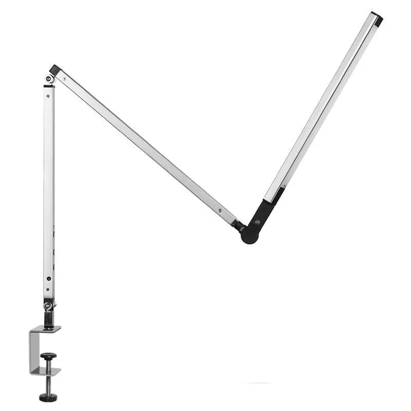 Black LED clip desk lamp with adjustable folding arm and remote control on a wooden desk.