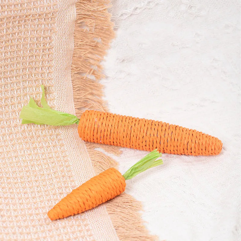 Assortment of interactive cat toys including carrot bites, paper toys, ringing stones, and dental sticks in two sizes