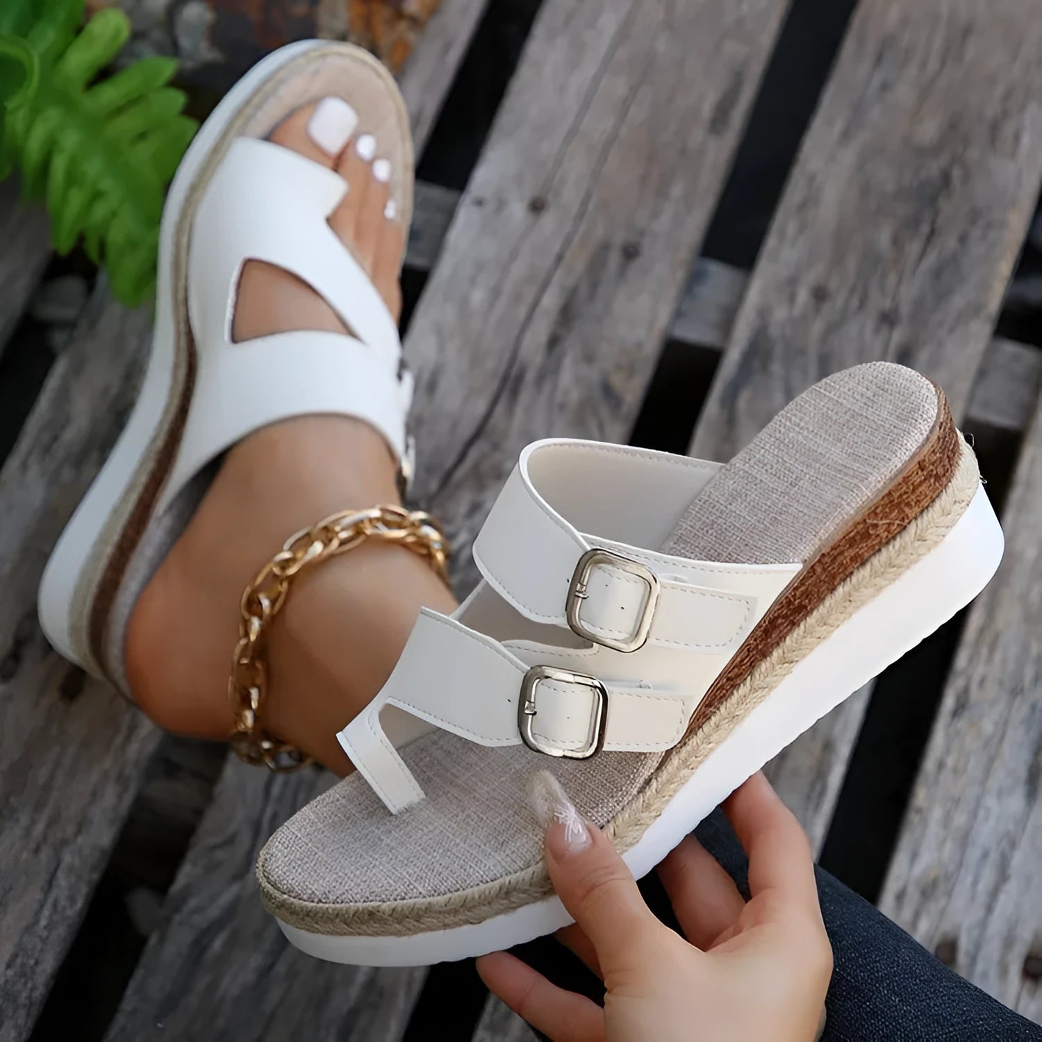 White patent leather women's wedge sandals with a woven design and peep toe on a rubber sole.