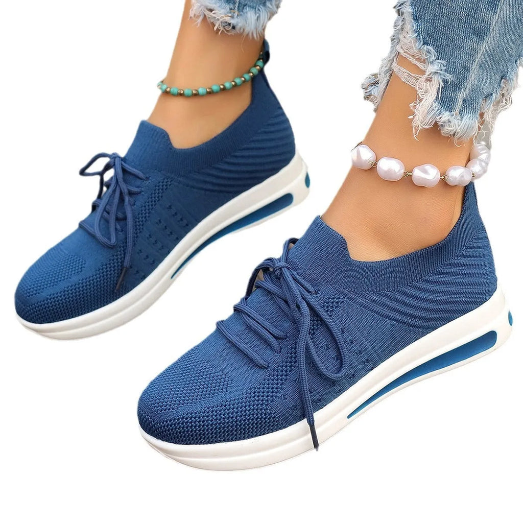 Women's red fly-knit casual sneakers with round toe and lace-up front on a white background