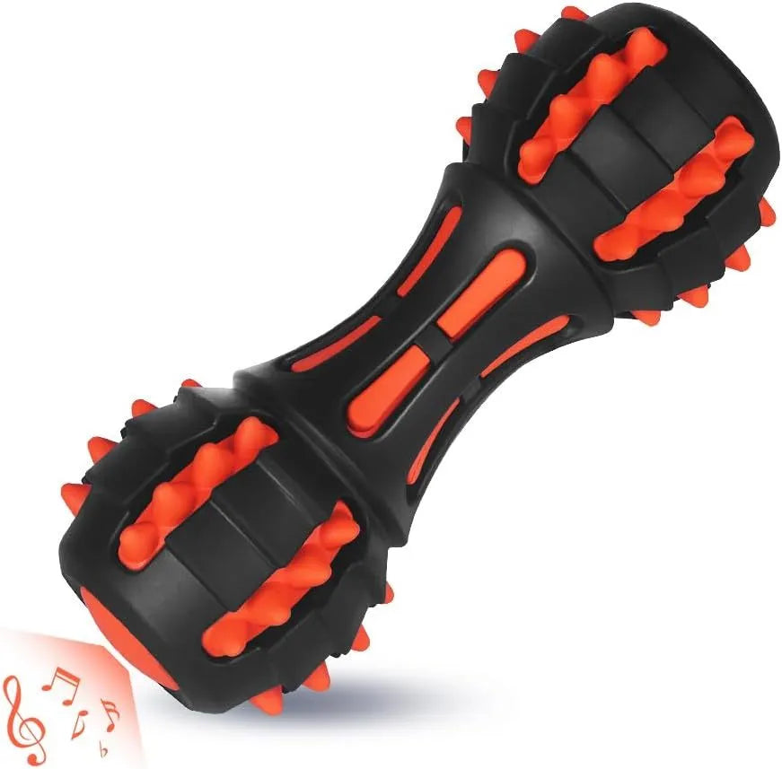 Red dumbbell-shaped durable rubber dog chew toy for aggressive chewers on a plain background.