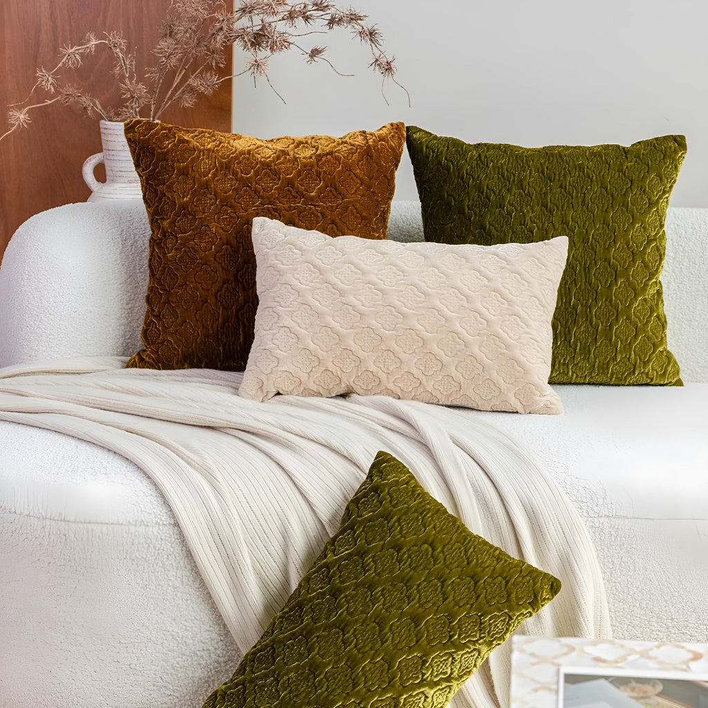 Brown gold antique quilted square cushion pillow on a sofa next to a green waist pillow.
