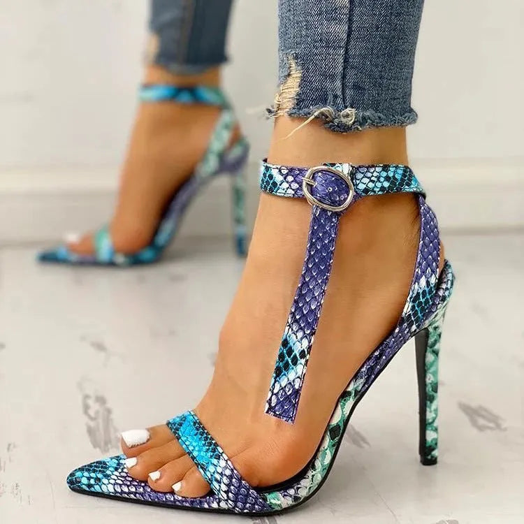 Blue serpentine-style women's high heels with buckle fastening and hollow-out details, shown from the side.