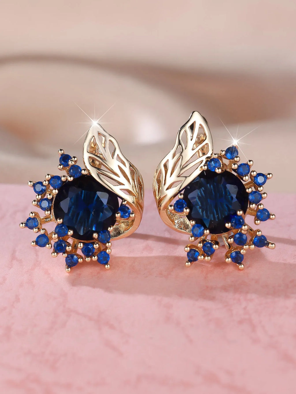 Rose gold coloured feather and flower design earrings with a choice of coloured zircon centre stones.
