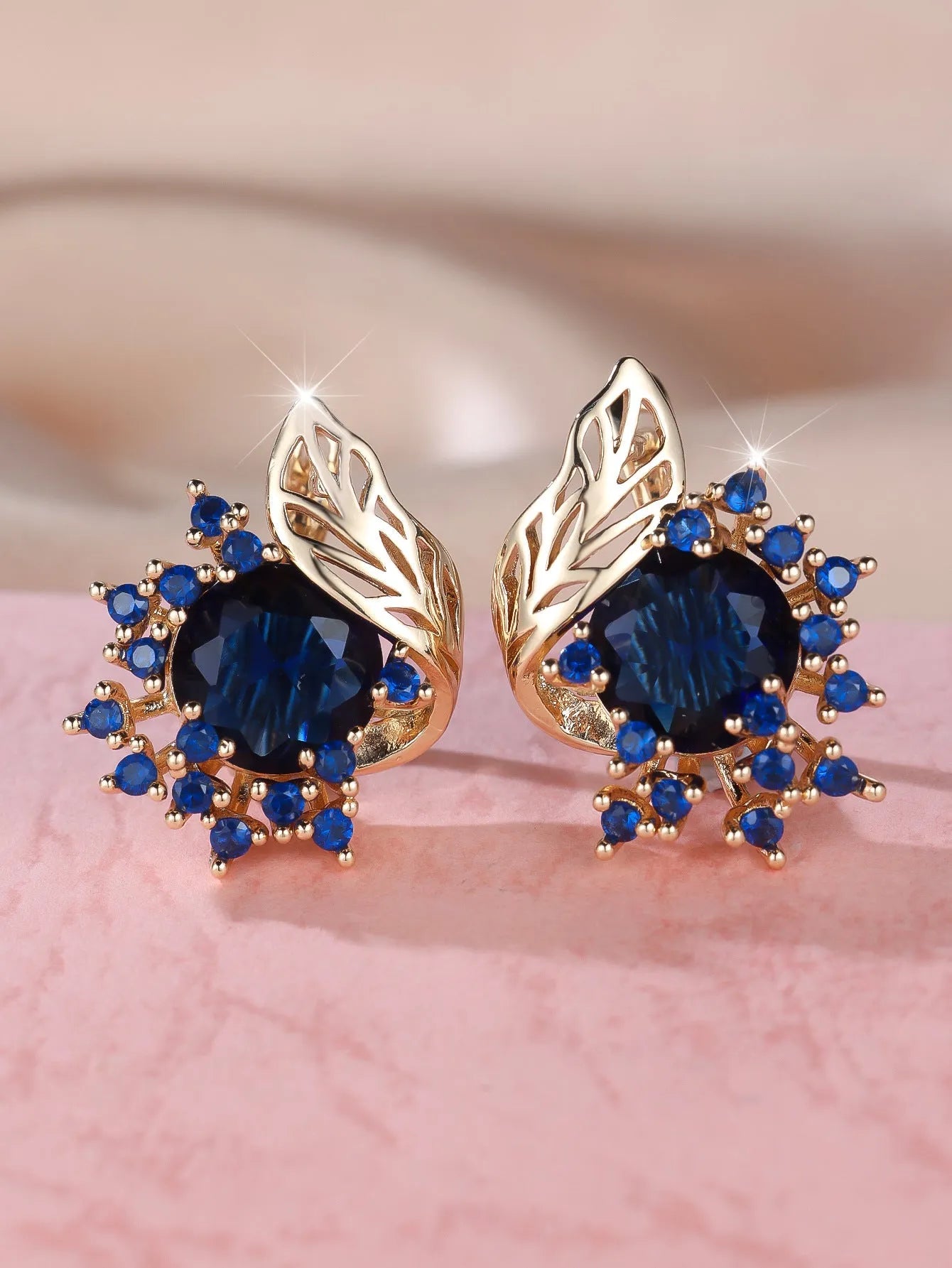 Rose gold coloured feather and flower design earrings with a choice of coloured zircon centre stones.