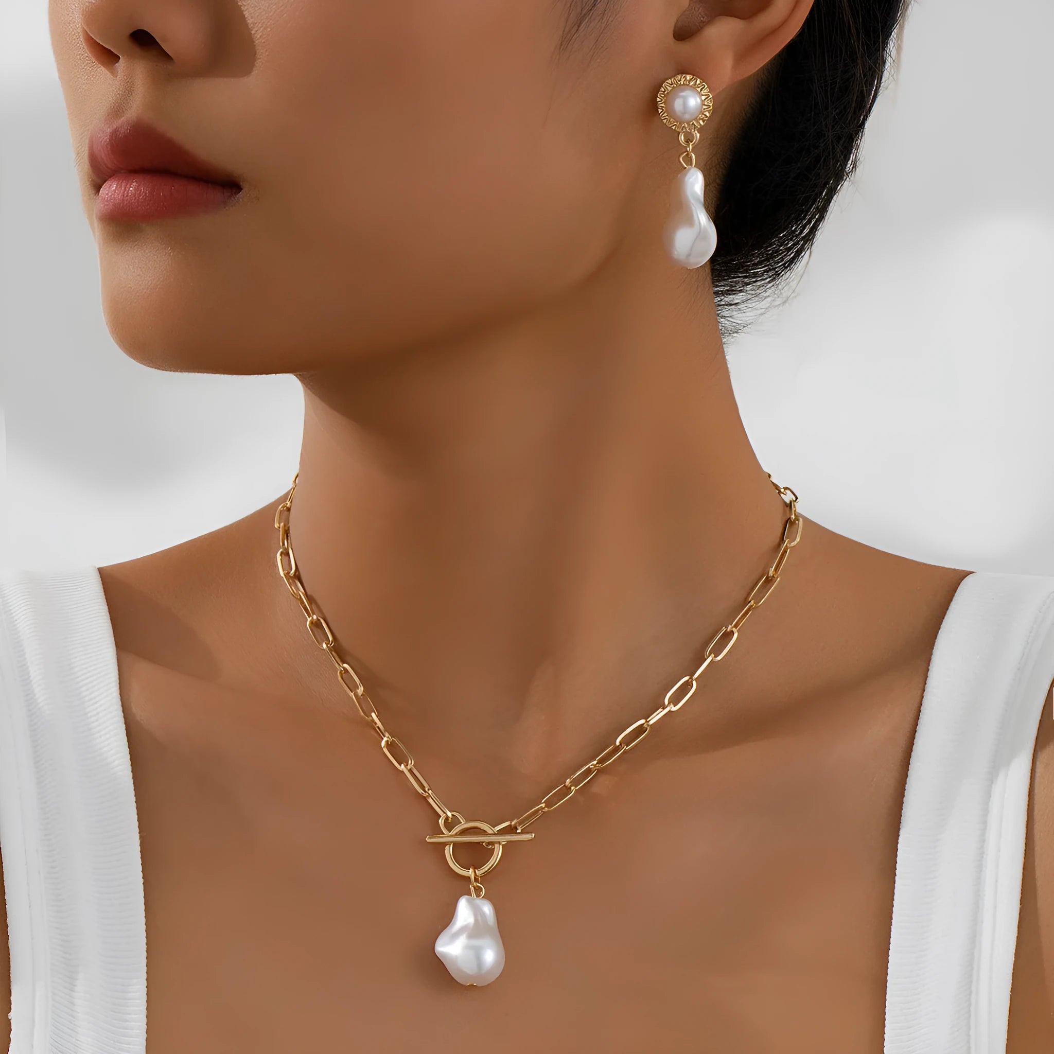 Gold baroque pearl pendant necklace and matching stud earrings set in retro style
