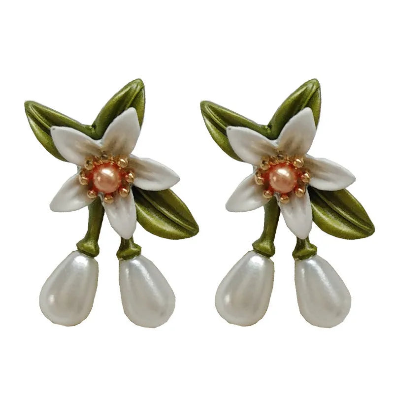 A pair of women's alloy flower-shaped clip-on earrings with contrasting sterling silver needle floral details.