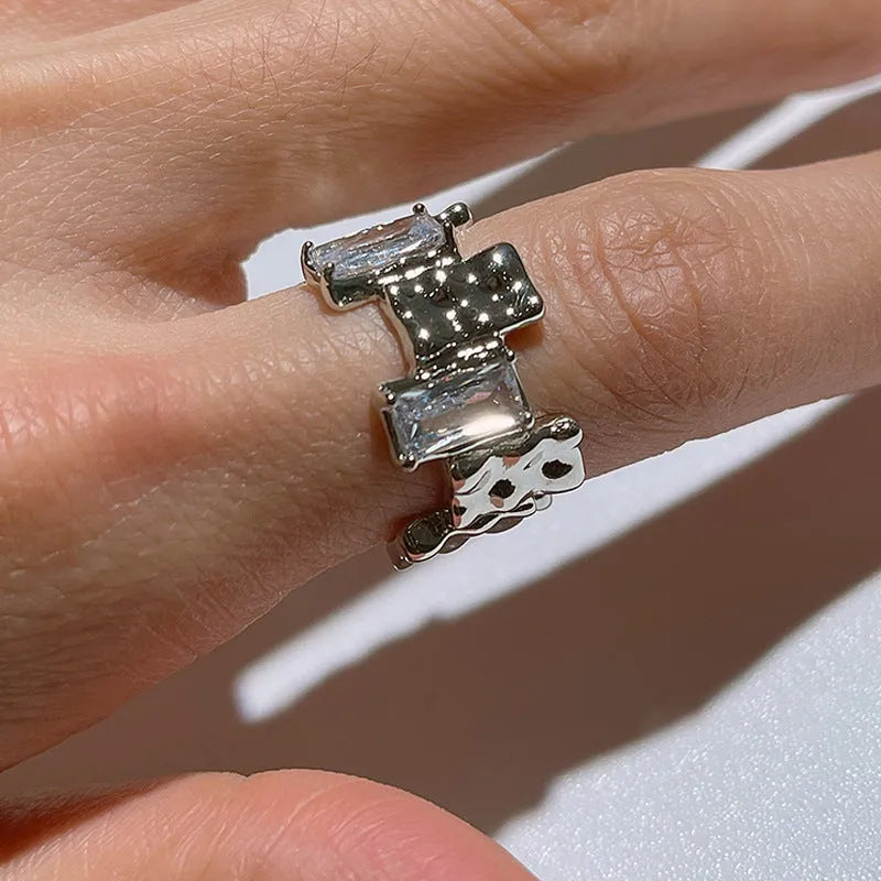Silver geometric cross ring with open zircon gemstone setting and three-dimensional decoration