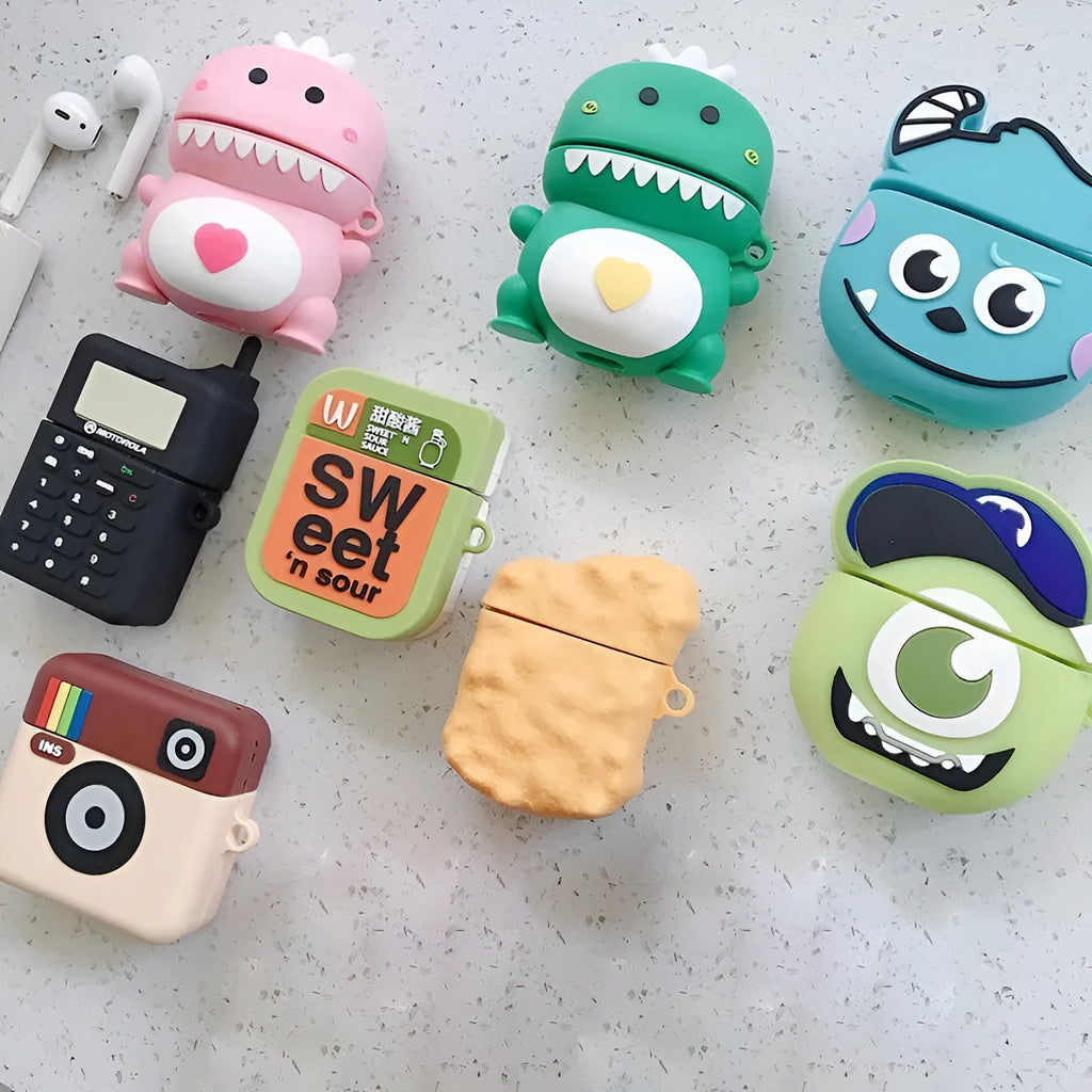 Silicone AirPod case with cartoon animal design in multiple colour options on a table.