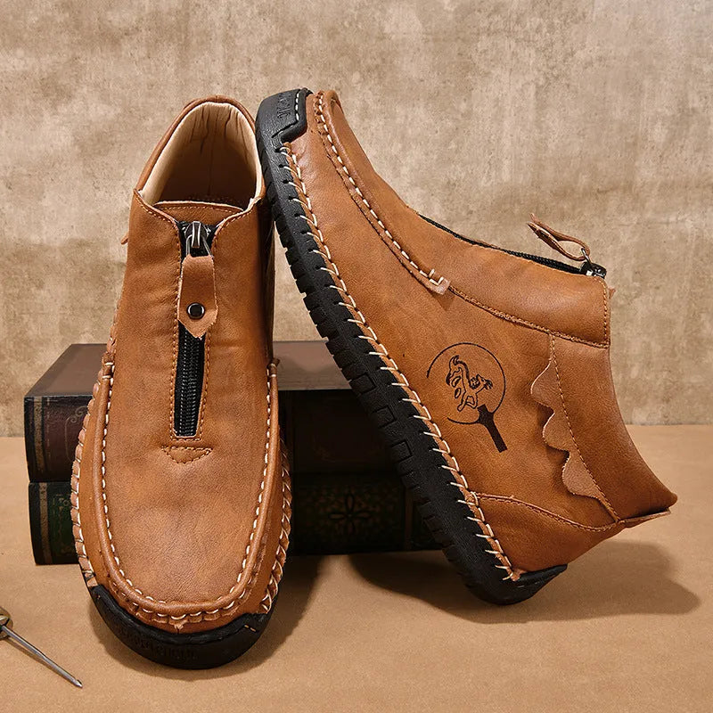 Men's black slip-on leather loafers with a round toe and visible stitching on a sewn rubber sole.
